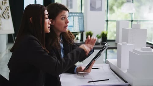 Real Estate Agency Employees Designing Building Blueprints