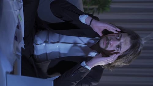 Vertical Video of Smoke comes out of the head of the confused businessman.