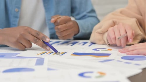 Close up of Mixed Race People Working on Documents