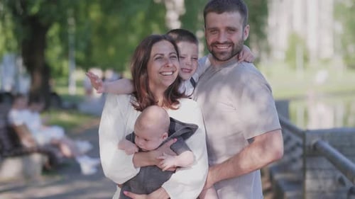 Beautiful Happy Family Husband and Wives and Two Children Boy Portrait in Summer