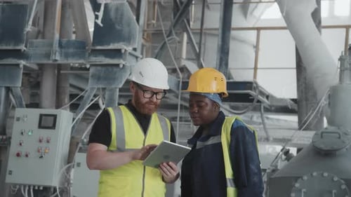 Engineer And His Female Co-worker Using Digital Tablet