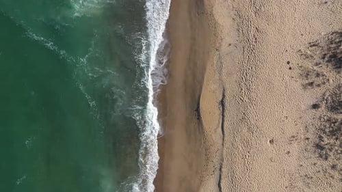 Aerial Slow Motion View of Remote Sandy Beach and Sea Waves by Drone