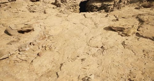 Desert View of Weathered Rocks and Dry Land Under a Bright Sky