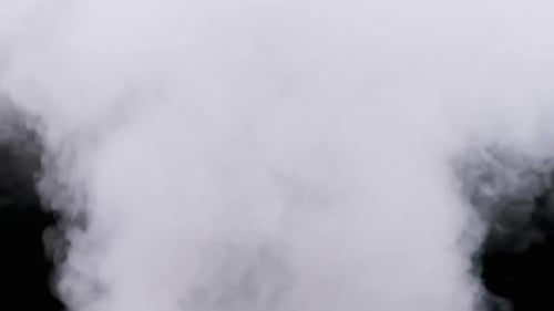 Real Explosion Vapor or Smoke Clouds Rise Up on Black Background in Slow Motion