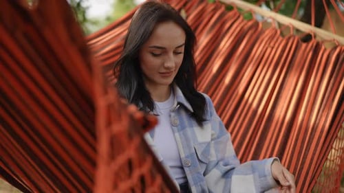 Woman Relaxes in Hammock After Closing Laptop
