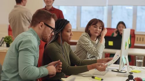 Three Multiethnic Colleagues Employees Cooperating in Office Talking Working Together at Workplace