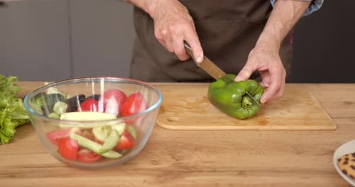 Adult Preparing Healthy Vegetable Salad in Kitchen
