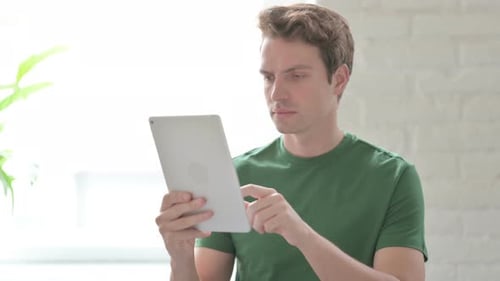 Young Adult Using Tablet Indoors During Daytime
