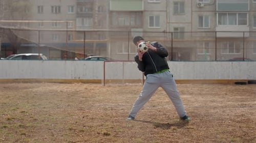 Man Practicing Soccer Ball Juggling Outdoors Urban Setting