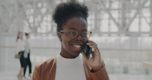 Confident Businesswoman Talking on Phone in Modern Office