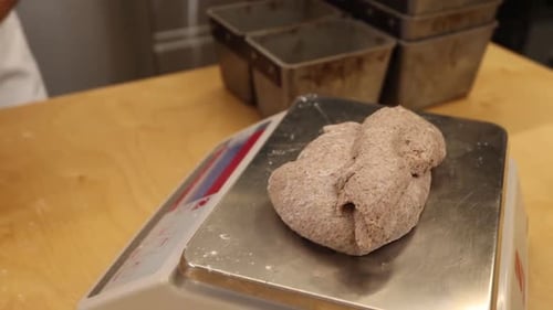 a chef makes bread in a bakery