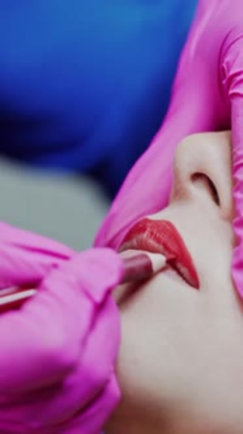 Cosmetologist Applying Lip Liner on a Woman