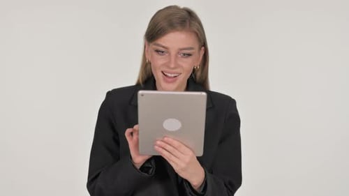 Woman Celebrating Success While Using Tablet