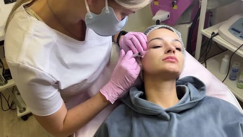 Woman Receiving Facial Injection in Medical Clinic