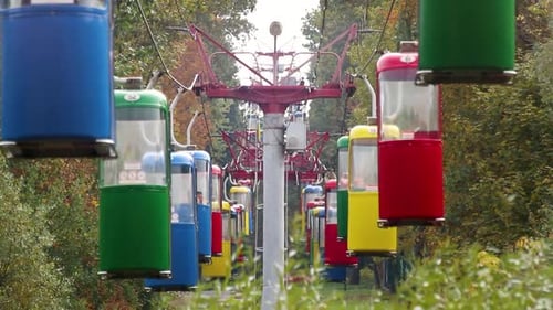 Colorful cableway cabins in autumn city park