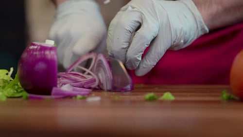 Chef Hands Dicing Red Onion Slices on Cutting Board
