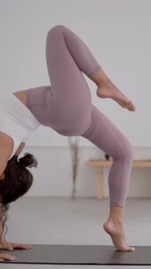 Vue latérale complète du corps d'une jeune femme latine en tenue de sport faisant de l'exercice dans un yoga moderne