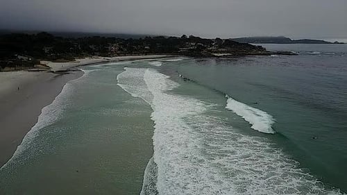 AERIAL - An overcast day on the beach, Encinitas, California, wide shot forward