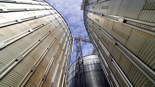 Tall Grain Silos Against a Blue Sky