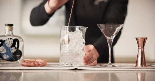 Hospitality, person and bartender stirring ice in glass for catering, service