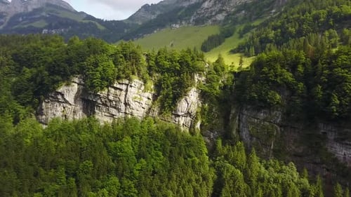 right to left pan over the cliff adge with a small waterfall in the middle
