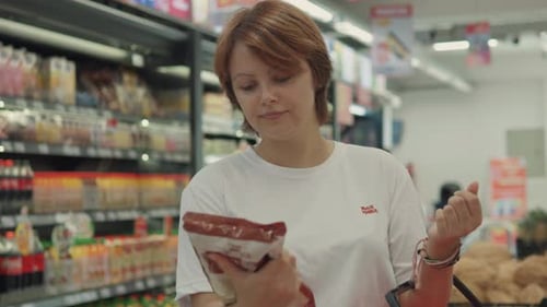 Young Woman Choosing Sugar in the Supermarket Close Up