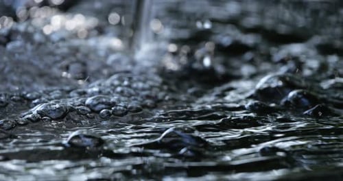 Water Flowing with Bubbles in Outdoor Setting
