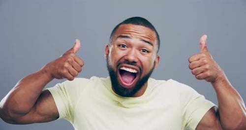 Enthusiastic Man Smiles and Gives Thumbs Up