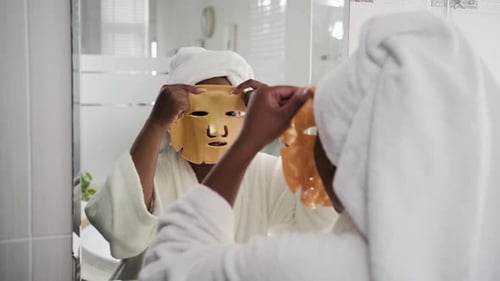 Girl Wearing Anti-wrinkle Sheet Mask on Face during Beauty Procedures at Home