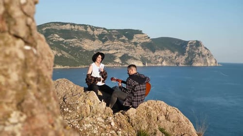 Couple in Love on a Mountaintop Overlooking the Sea