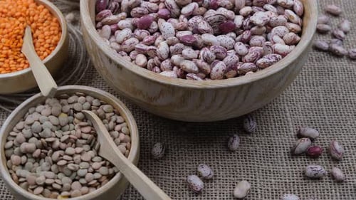 Colorful Beans and Lentils in Wooden Bowls