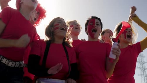 Enthusiastic Fans Celebrate Together Outdoors with Drum
