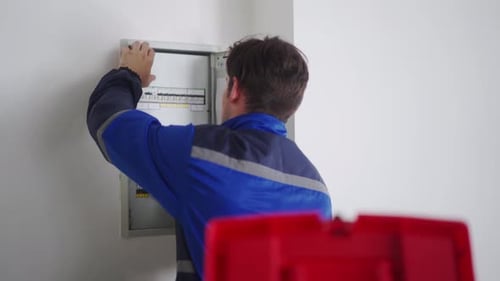 Electrician Opening Electrical Panel for Service and Repair