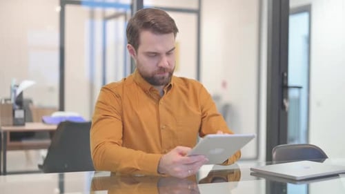 Man Using Tablet Device in Modern Office