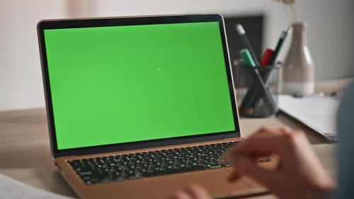 Laptop with Green Screen in Office Environment