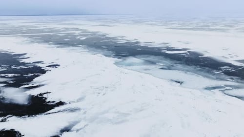 Drone shot of frozen ice and snow drifts on lake Michigan