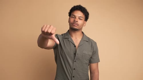 Young Adult Gives Thumbs Down in Studio