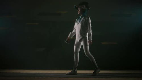 Fencer Putting on Epee Mask and Taking Starting Pose with Foil Sword