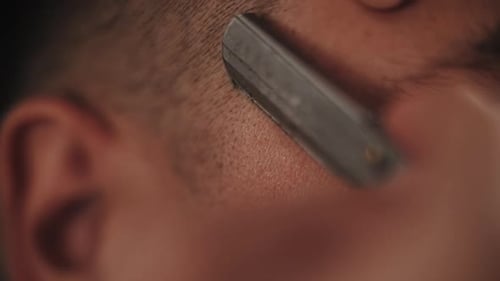 Man's Hairline Shaved with Straight Razor in Close View