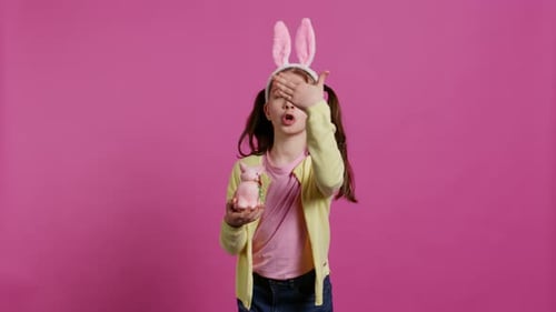 Lovely Little Girl with Bunny Ears Sending Air Kisses in Studio
