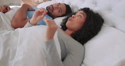 Couple Lying in Bed Talking Together