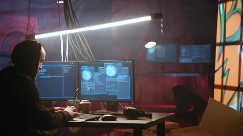 Hacker Using Computer to Run Malicious Code in Foggy Dark Basement