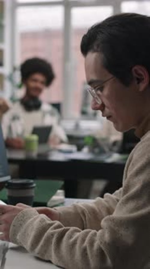 Male Programmer Using Smartphone at Workplace