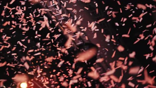 Confetti falling down in front of a stage at an event