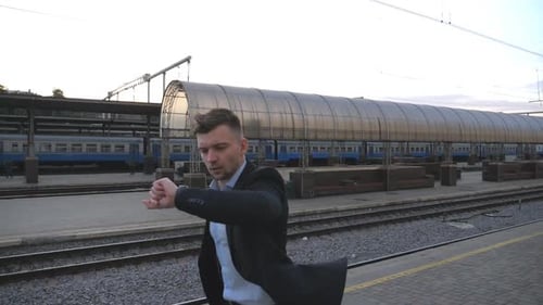 Successful Businessman Running Through Railway Station and Looking at Watch Young Man is Late for