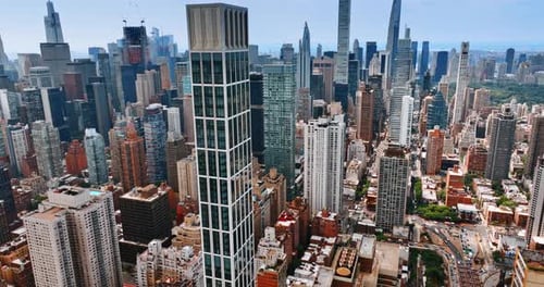 Descending footage above the stunning Manhattan skyscrapers at daytime.