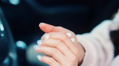 Close Up View of Female's Hands Using Spray for Disinfection Girl Sit in Car During Travelling Break