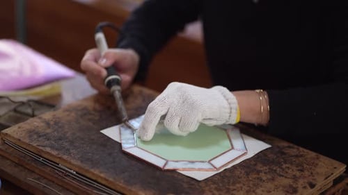 Artisan Creating Stained Glass Art in Workshop
