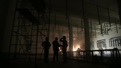 Silhouettes of Construction Workers Inspecting a New Build
