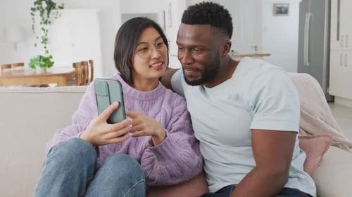 Couple Relaxing at Home Looking at Phone